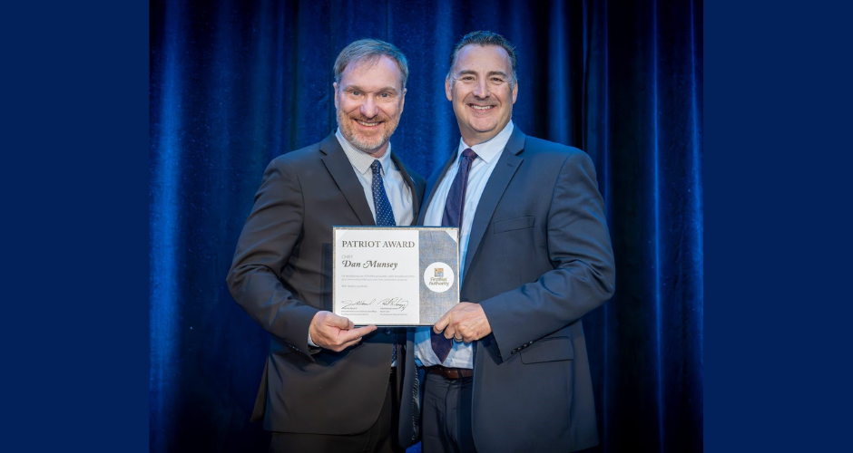 Joe Wassel, Executive Director and CEO of the First Responder Network Authority (left), presents County Fire Chief Dan Munsey (right) with the Patriot Award.