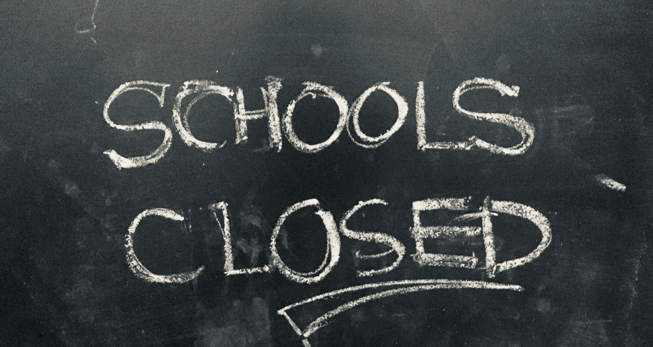 BLACKboard with the words SCHOOLS CLOSED written in chalk