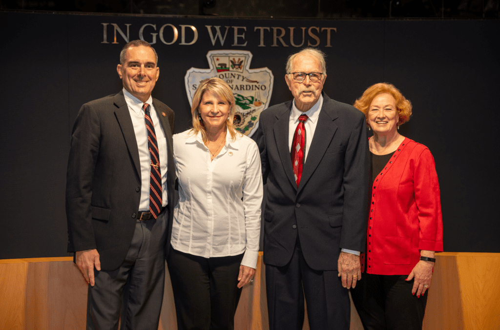 Supervisor Rowe stands next to her husband, her father, and her stepmother