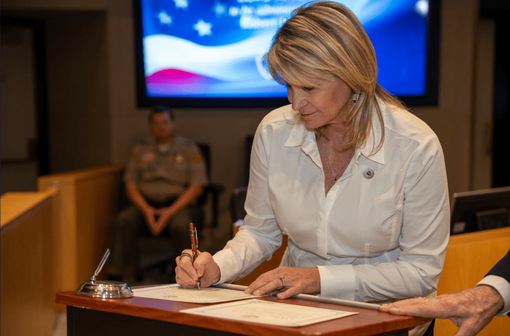 Supervisor Rowe signs official paperwork