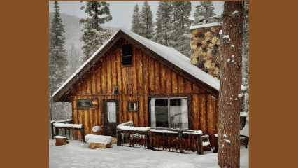 A cozy winter cabin in a mountain community on a snowy winter day. Mmmmm.....