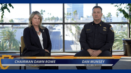 A screenshot from a video interview showing Supervisor Dawn Rowe seated next to San Bernardino County Fire Chief Dan Munsey