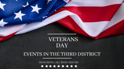 An American flag sits against a charcoal grey background along with the words veterans day events in the third district honoring all those who served