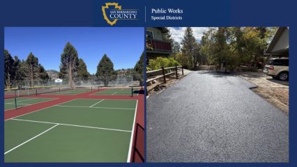 San Bernardino County Public Works Special Districts banner showing newly resurfaced tennis courts and a freshly paved residential roadway surrounded by trees.