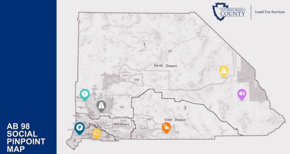 Graphic from San Bernardino County Land Use Services showing an “AB 98 Social Pinpoint Map” of San Bernardino County with color-coded location markers highlighting areas for public feedback related to truck routes and traffic concerns in unincorporated communities. The county and department logos appear in the upper-right corner.