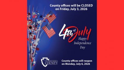 Graphic with a blue background and patriotic red, white, and blue decorations featuring small American flags and star-shaped streamers along the left side. Large white text at the top reads, "County offices will be CLOSED on Friday, July 3, 2026." In the center, stylized red and white lettering says, "4th of July," with "Happy Independence Day" underneath in white script. The bottom of the graphic features the San Bernardino County logo and additional text stating, "County offices will reopen on Monday, July 6, 2026."