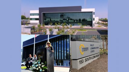 Collage featuring the new San Bernardino County Valley Communications Center in San Bernardino. The top image shows the modern three-story facility with a sleek glass façade and contemporary black-and-white exterior design. The lower left image shows Third District Supervisor Dawn Rowe speaking at a podium during the grand opening ceremony, with attendees seated behind her and floral arrangements in front of the podium. The lower right image shows the facility's monument sign displaying the San Bernardino County logo and the words "Valley Communications Center" alongside the address, 153 South Lena Road.