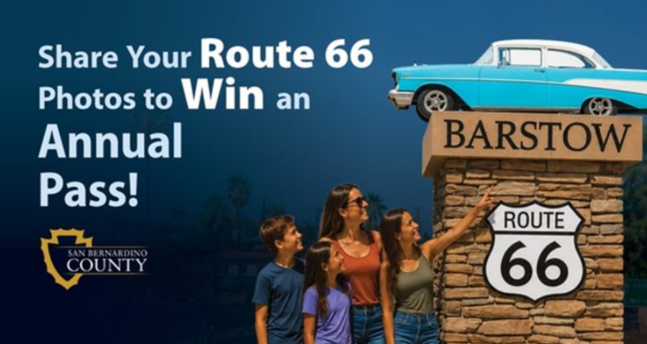 A woman and three children look at the Barstow Route 66 pedestal statue. One of the youngsters is pointing at it. Text on the image says SHARE YOUR ROUTE 66 PHOTOS TO WIN AN ANNUAL PASS! there's also a county logo on there.
