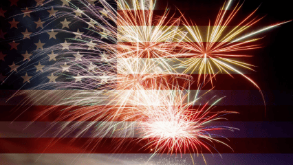Fireworks burst in air over an American flag background